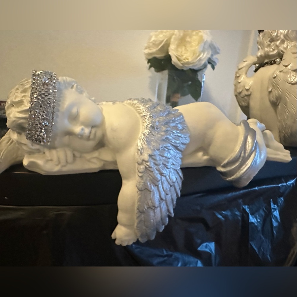 Sleeping cherub in silver